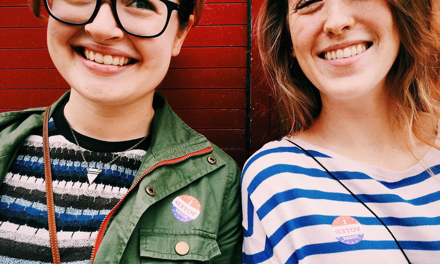 Two young women vote